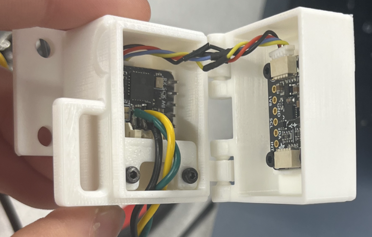 Hinged electronics housing with boards mounted inside